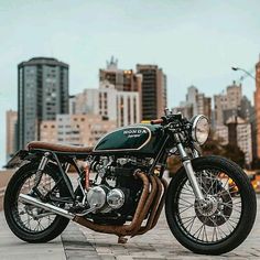 a motorcycle parked in front of a cityscape