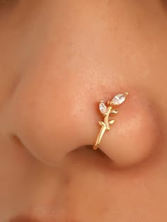 a close up view of a baby's nose with a tiny cross on it