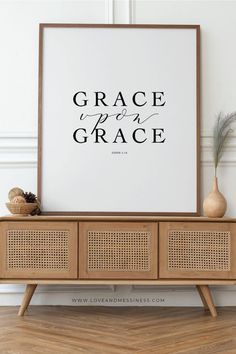 a poster with the words grace upon grace on it in front of a wooden cabinet