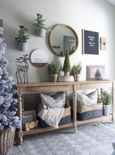 a living room filled with lots of furniture and christmas tree in front of a mirror