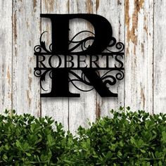 a metal sign that reads robert's and is on the side of a wooden wall