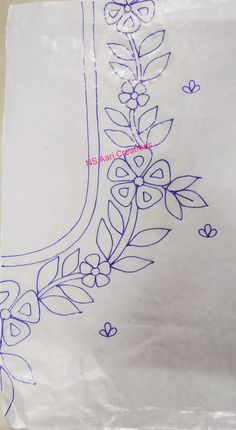 a piece of white paper with blue embroidery on it