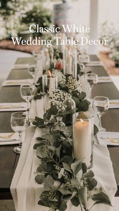 a long table is set with candles and greenery for an elegant dinner or party