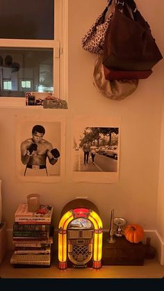 there are pictures on the wall and an old radio in front of it, along with other items