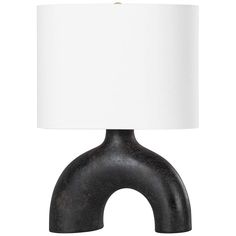 a black and white table lamp with a white shade on the top, against a white background