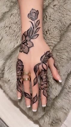 a woman's hand with flowers on it