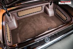 the interior of an old car with carpeted flooring and leather trimmings