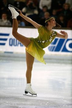 a female figure skating on an ice rink