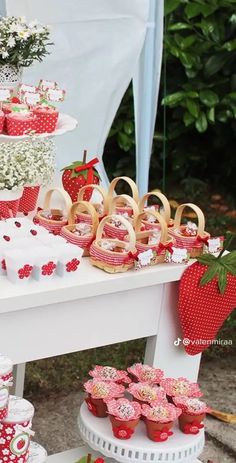 a table topped with lots of cupcakes and cakes