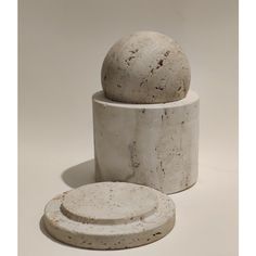 three white marble containers stacked on top of each other, one with a round lid