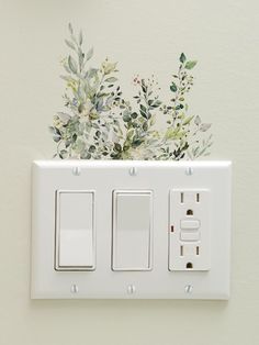 a white light switch sitting next to a wall with flowers painted on the switchesticks