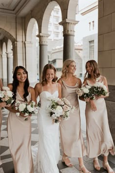 the bridesmaids are all wearing different dresses