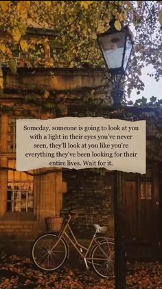 a bicycle is parked in front of a building with a sign that says, sometimes someone is going to look at you with a light in the eyes you've