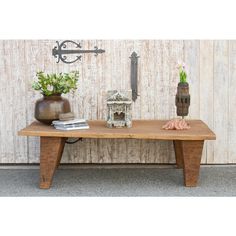 a wooden table with two vases on it