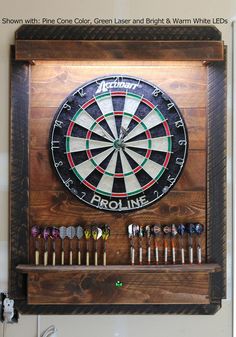 a dart board mounted to the side of a wall with darts and darts on it