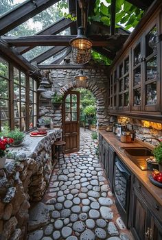 an outdoor kitchen with stone walls and flooring is shown in this image, it looks like the inside of a house