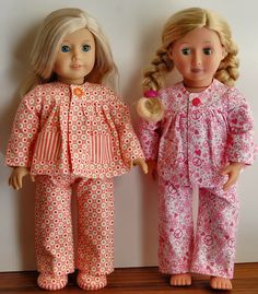 two dolls are standing next to each other