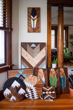 several pieces of wood are arranged on a table in front of a mirror and potted plant