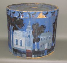 a blue and white container with houses painted on it