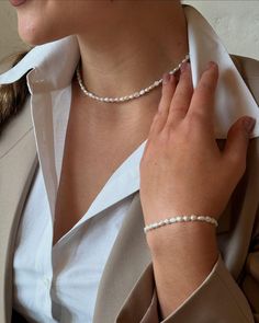 Elevate your bridal look with our Minimalist Pearl Choker Necklace and Bracelet Set. Crafted from real freshwater pearls, this exquisite jewelry set embodies elegance and simplicity, making it a perfect choice for weddings or special events. Ideal for brides and bridesmaids alike, this timeless pearl jewelry adds a touch of sophistication to any outfit. Gift your loved ones an unforgettable surprise with this stunning set, perfect for bridesmaid gifts and cherished memories. Order now and embrac River Pearls, Pearl Choker Necklace, Pearl Choker, Freshwater Pearl Necklaces, Exquisite Jewelry, Brides And Bridesmaids, Bridal Looks, Bracelet Set, Pearl Jewelry