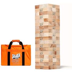 an orange bag next to a wooden block tower