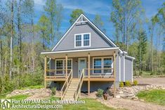 a small house in the woods with stairs leading up to it