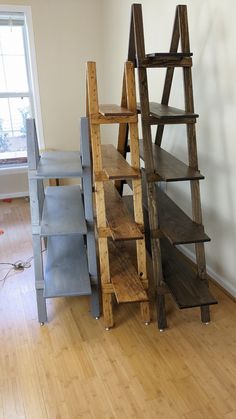 several wooden shelves stacked on top of each other in a room with hard wood floors