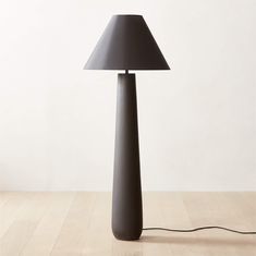 a black lamp sitting on top of a wooden floor