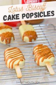 several popsicles on a cooling rack with peanut butter and caramel drizzle