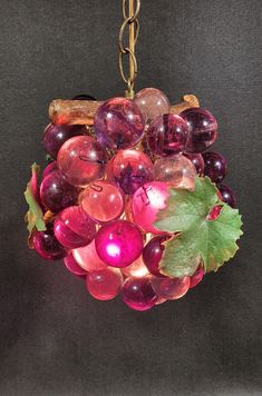 a bunch of grapes hanging from a chain