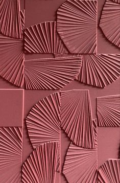 a close up view of a pink wall with many different shapes and lines on it