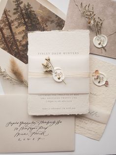 the wedding stationery is laid out on top of each other