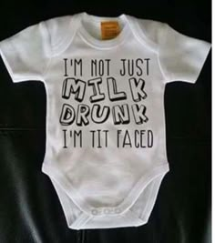 a white baby bodysuit that says i'm not just milky drunk, i'm it tamed