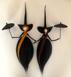 two long hair dolls with umbrellas on their heads