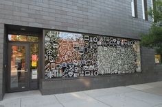 a building that has some graffiti on the side of it's glass front door