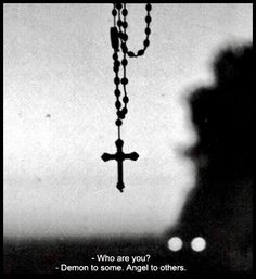 a black and white photo with a cross hanging from it