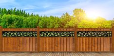 a wooden fence with wrought iron work on it