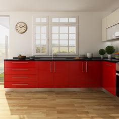 a kitchen with red cabinets and a clock on the wall next to it's windows