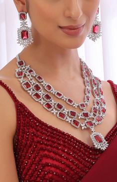 This Stunning Three Layered Ruby Red CZ Long Necklace is a must-have piece of jewelry for anyone looking to make a statement. This stunning CZ necklace features a combination of Indian, Pakistani, and American diamond jewelry, making it a truly unique and eye-catching accessory. Necklace Length Is Adjustable With Extension Chains Earrings Have Pushbacks.  Customized orders takes 3 to 4 weeks, depending on piece requirements.  The Ombre Designs Jewelry pieces can be customized in accordance with your requirement.  Please Email or Whats app on : +91 8448833193 / sonalikamehra@theombredesigns.com Ruby Jewelry Necklaces Diamond, Luxury Ruby Jewelry For Formal Occasions, Luxury Red Necklaces For Party, Luxury Red Temple Necklace For Formal Occasion, Luxury Red Jewelry For Celebration, Luxury Red Jewelry For Festive Season, Luxury Red Jewelry For Formal Occasion, Luxury Red Jewelry With Zari Work, Luxury Ruby Jewelry For Marriage