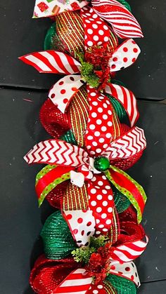 a christmas tree made out of red and green ribbons with polka dot bows on top