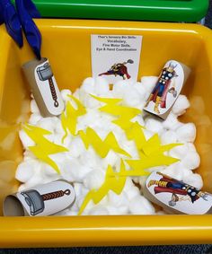 a yellow plastic container filled with cotton and toys