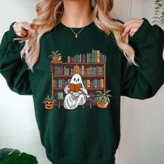 "This bookish Witchy Ghost Sweatshirt is the perfect gift for the Book Lover, trendy bookish college sweatshirt for your best friend, school reading teacher gift, literature class or retro book club team shirts for work. This Design was especially created by Project Love Life to fit  your life as a bookworm! :) This can also make a Great Halloween gift for a newly graduated son, daughter, sister, brother, grandson or granddaughter to name a few. This soft, comfy crewneck sweatshirt with cute ret Spooky Library, Cottagecore Pumpkin, Librarian Appreciation, Retro Bookshelf, Library Shirt, Ghost Sweater, Comfy Crewneck, Witchy Gifts, Aunt Birthday