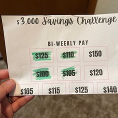 a person holding up a $ 3, 000 savings challenge