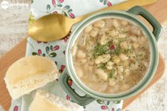 a bowl of soup with bread on the side