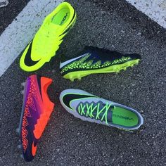 four pairs of nike soccer cleats on the ground