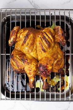 a cooked chicken sitting on top of a grill