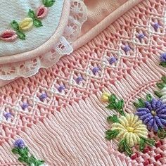 two pieces of embroidered fabric with flowers on them