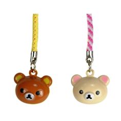 two key chains with different designs and colors on the handles, one has a bear head