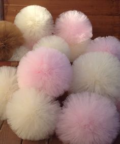 several pom - poms sitting on top of a wooden table