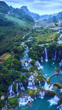 an aerial view of waterfalls and lakes in the tropical jungles with lush green trees